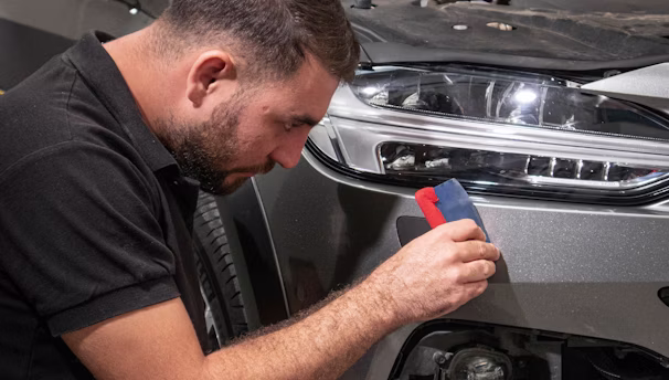 a man working on a car in a garage
